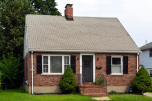 Old Single-family One-level Red Brick Gable Roof House Exterior View In Brighton City, MA, USA