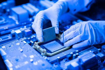 process of installation of processor in cpu socket, hands in gloves holding chip