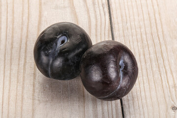 Two ripe sweet black plums