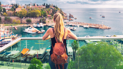 Wall Mural - woman tourist looking at panoramic view of harbor in the old city of antalya, turkey