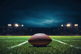 Fototapeta Fototapety sport - closeup of an American football ball on the grass of a stadium at night about to start a game - copyspace