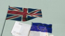 Animation of flag of european union and great britain over euro currency bills