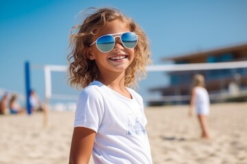 Wall Mural - summer holidays, vacation and children concept - smiling little girl in sunglasses on beach