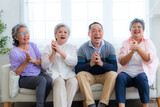 Fototapeta  - Happiness of the group females and male elderly sitting on the sofa. Senior people are talking and enjoy together at the living room. Joyful carefree retired senior friends enjoying relaxation.