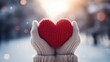 Captures a pair of hands clad in cozy knitted gloves, holding a red woolen heart against a snowy backdrop, evoking warmth and affection in the cold.