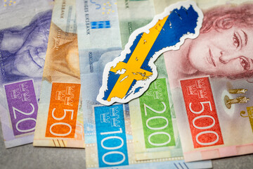 Wall Mural - Sweden money, Swedish krona banknotes, national flag and shape of Sweden, Financial concept business, gray background. copy space