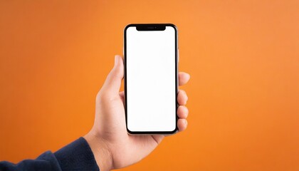 Hand using smartphone with blank screen, isolated orange background