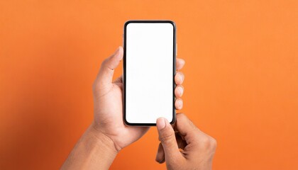 Hand using smartphone with blank screen, isolated orange background 