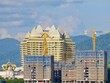 © Watthana Tirahimonch - Tower Crane Operating At Development Site, City, crane and construction with apartment buildings, property development, infrastructure, Urban landscape, civil engineering, Casino buildings in Laos