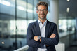 © areef - A business man standing with his arms crossed, wearing a blue shirt in a office setting with blurred background