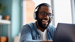 © Studio Nova - A man in a casual outfit works on a laptop in his office
