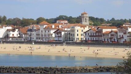 Wall Mural - Tourists on the sand of Grande Plage beach in Saint-Jean-de-Luz, France