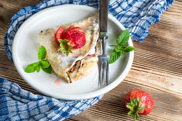 Wall Mural - Polish pancakes with jam, cheese and strawberries.