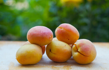 Wall Mural - Yellow apricots are scattered on the board