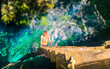 Tourist guide blue turquoise water limestone cave sinkhole cenote Mexico.