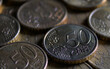 50 euro cent coin lying in a row of coins. Macro photography in dark tones.