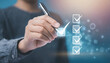 © Merlin - hand use pen to tick correct sign mark in checkbox for quality document control checklist and business approve project concept.