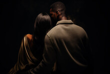 Couple Against Dark Background, Backs Touching, Symbolizing Relationship Cooling. Beautiful View, Evoking Emotional Depth And Contemplation. Couple On The Dark Wall Background, View From Back
