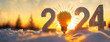 New Year 2024 Concept with Sunlit Snowy Figures. The golden light of dawn illuminates '2024' sculpted in snow, representing the start of a new year filled with possibilities