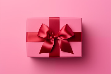 Wall Mural - Gift or present for birthday, Valentines Day or Mothers Day. Beautifully decorated giftbox with ribbon bow isolated on pink background.