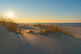 Fototapeta  - Wydmy plaża o zachodzie słońca nad morzem oceanem