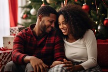 Young Happy Black Couple Wearing Xmas Pajama Plaid Bottoms Shirts Sit In Living Room And Celebration Christmas At Home.