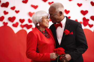 Wall Mural - Happy senior african american couple with hearts background.