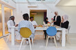 © .shock - In the sacred month of Ramadan, a Muslim family joyously comes together around a table, eagerly awaiting the communal iftar, engaging in the preparation of a shared meal, and uniting in anticipation