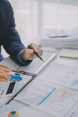 Financial analysts analyze business financial reports on a digital tablet planning investment project during a discussion at a meeting of corporate showing the results of their successful teamwork.