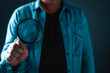 Businessman standing and holding magnifying glass Searching for information. Finding and research concept.