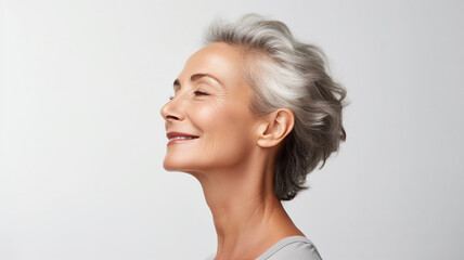 Wall Mural - side view of a middle aged woman on white background