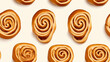 Pattern of cinnamon roll pastries on a light background. Seamless texture.
