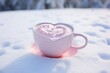  a cup of hot chocolate with a heart in the middle of it on a pink saucer in the snow.