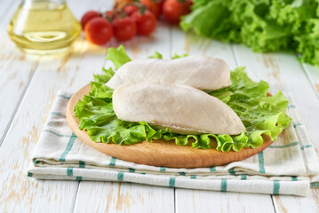 Wall Mural - Boiled chicken filled with spices and herbs on a wooden table.