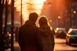 Lovers man and woman on the street of a big city in the rays of the sun.  In evening city street. Woman and man gently embracing, romantic french atmospheric moment. Back view