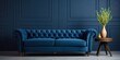 Classic navy sofa and wooden accents in a vintage blue lounge.