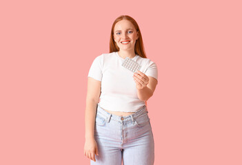 Wall Mural - Young woman with contraceptive pills on pink background