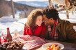 Mixed race couple on valentine's date winter time. Enjoying outdoors, spending quality free time in Christmas, on New Year. Love makes us warm.