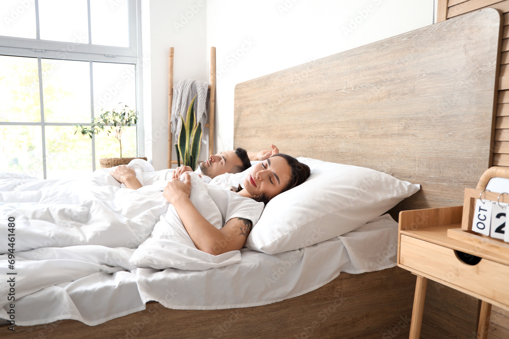 Young couple sleeping in bedroom