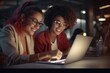 © Fotograf - Two women sitting at a table, focused on a laptop. Suitable for business, teamwork, and technology concepts