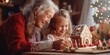 © Fotograf - An older woman and a young girl are seen in the process of decorating a gingerbread house.