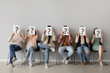 © Pixel-Shot - Applicants holding paper sheets with question marks near light wall