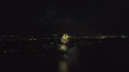 Wall Mural - Aerial view of bright fireworks exploding with colorful lights over sea shore on US Independence day holiday