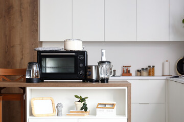 Sticker - Wooden table with modern appliances in interior of contemporary kitchen