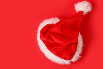 Wall Mural - Santa Claus hat on red background