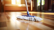 Mop cleaning a parquet floor of a brightly lit living room. Home cleaning concept and cleaning service. Copy space.