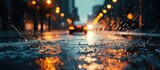 Fototapeta  - Car headlights illuminated the rainy city streets, with water splashing and spilling on the close-up pavement.