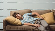 © Dirk - copy space, Young man taking a nap on a pillow on background. National Napping Day. Young man resting while tired. Peaceful scene.