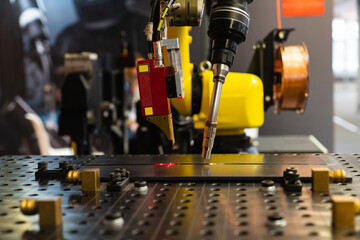 Leinwandbilder - Automatic welding robot in a modern factory in operation
