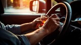 Fototapeta  - A Person Holding a Glass of Alcohol While Driving